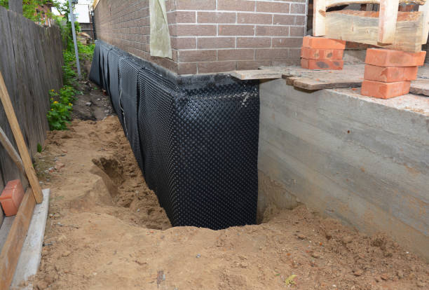 SJ Waterproofing Pros technician performing targeted Basement Waterproofing assessment in Highland, IL